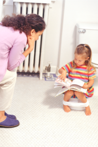 Reading a book or using a potty time app is one of the many potty training tips to lead success with the child-led approach.
