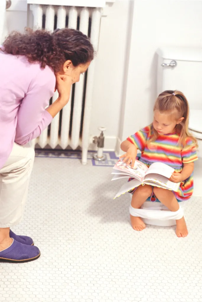 Reading a book or using a potty time app is one of the many potty training tips to lead success with the child-led approach.